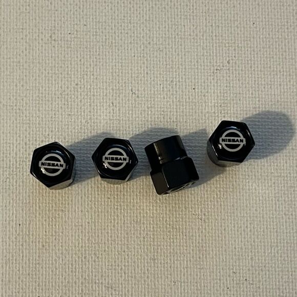 Nissan Logo Valve Stem caps in Black set of 4 NWT - Picture 1 of 4